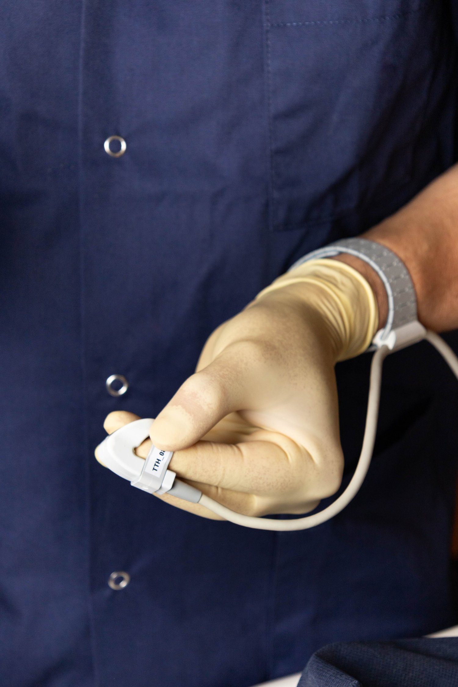 Practitioner wearing SibUS-In ultrasound device on finger